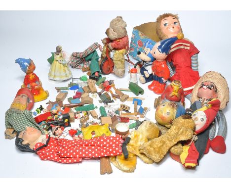A large assortment of vintage children's toys to include puppets, character figures including Noddy and other Disney, pull-al
