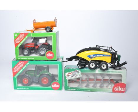 A group of Siku 1/32 farm model issues including trio of boxed tractor and implements plus loose Britains baler and playworn 