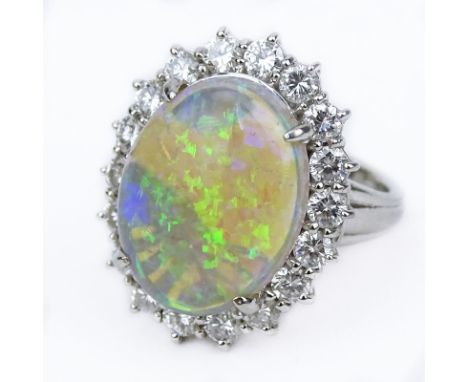 Vintage Oval Cabochon Opal, Diamond and Platinum Ring. Opal measures 16mm x 12mm, with good play of multi color. Stamped Pt90