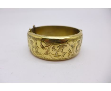 A 9ct gold on silver bangle, 38g