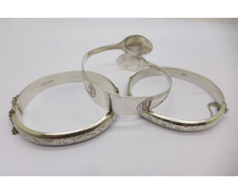 Two silver bangles, 30g, and one other bangle made from a pair of sugar bows
