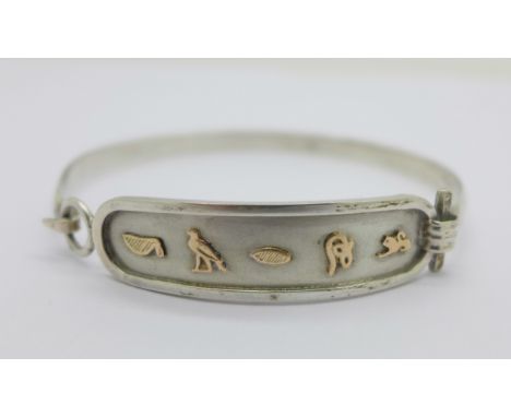A gold applied silver bangle, with control marks