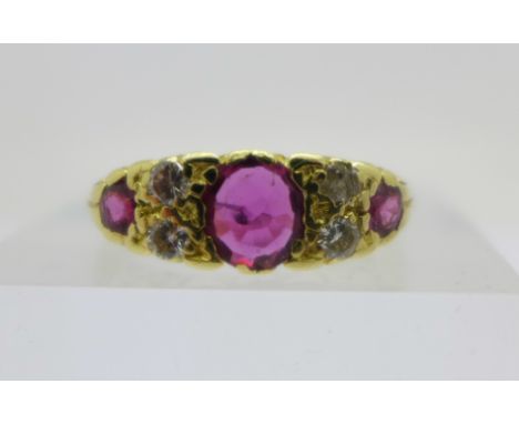 An 18ct gold, ruby and diamond seven stone carved claw ring, 4.7g, N, mark worn