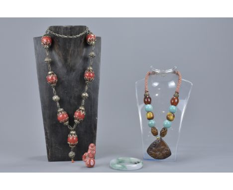 A red bead and filigree necklace together with a jade Chilong pendant beaded necklace possibly by London based Barbara Acton 