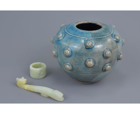 An Asian blue glazed pottery jar with studded decoration together with a jade archers ring and belt hook. jar 10.5cm tall&nbs