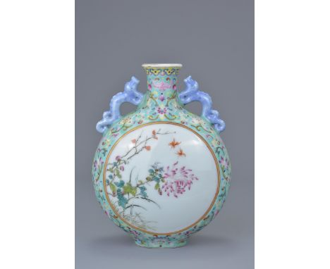 A Chinese 19/20th C. Famille rose porcelain moon flask with twin chilong handles. Four character mark of Qianlong to base. 15