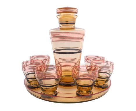 An Art Deco glass cocktail set, of pale amber colour with red and black banded decoration, comprising a circular tray, decant