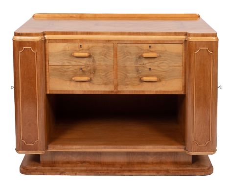 An Art Deco figured walnut inverted breakfront side cabinet, 1930s; with a quarter veneered top above for small drawers with 