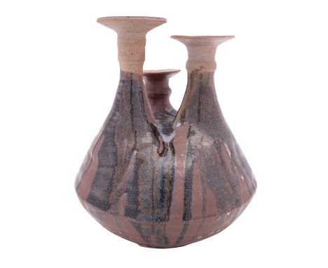 Attributed to Nic Collins, a stoneware candlestick the squat globular base with three raised and ribbed necks of differing he