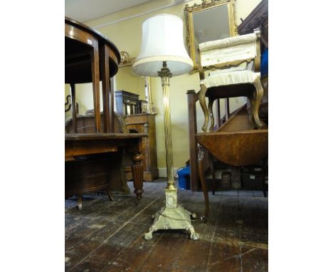 An Edwardian brass corinthium column lamp standard raised on a square stepped and weighted base with lions paw feet (adapted 