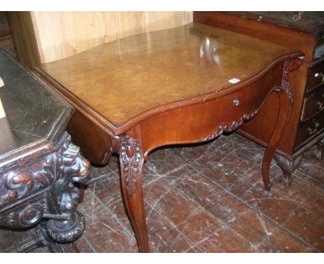 A mid-19th century continental mahogany sofa table with serpentine outline and two drop leaves over a single frieze drawer, r