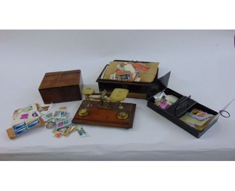 A set of small Victorian brass balance scales raised on an oak base, two sectional mahogany tea caddy and a tin money box wit