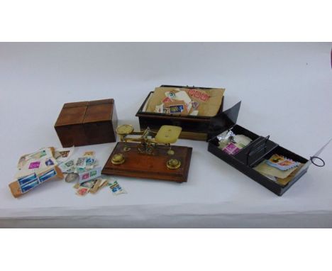 A set of small Victorian brass balance scales raised on an oak base, two sectional mahogany tea caddy and a tin money box wit