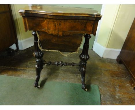 A Victorian rosewood ladies occasional table, the fold over top revealing a chessboard and backgammon board, the frieze drawe