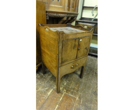 A Georgian mahogany tray top commode of square cut form, the front elevation enclosed by two doors over the original sliding 