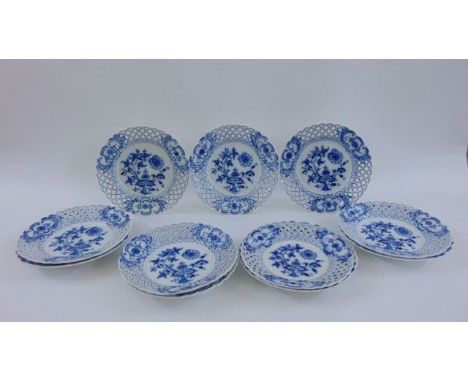 A collection of 19th century Dresden plates with a floral pattern, set within lattice work borders, comprising eleven plates,