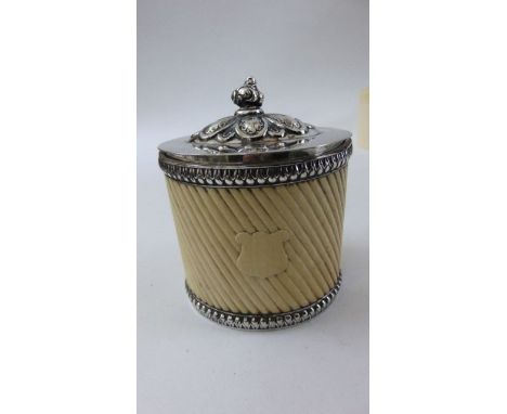 A 19th century ivory tea caddy with wrythen fluted detail, silver plated base and hinged cover