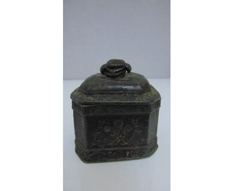A Regency period lead tobacco jar and cover, the body of rectangular form with canted corners with applied fleur-de-lys decor