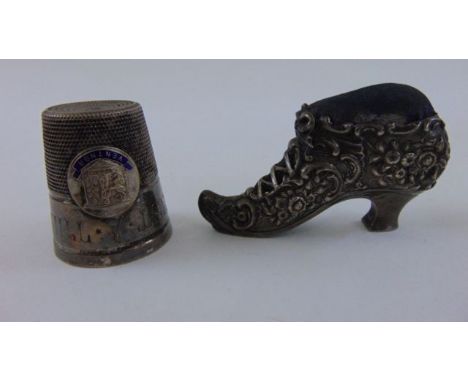 An Edwardian silver novelty pin cushion by Henry Mathews, Birmingham 1906 in the form of a ladies shoe, a silver plated thimb