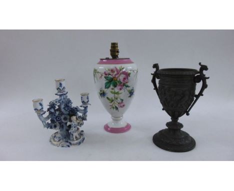 A 19th century French porcelain oil lamp base of urn form with hand painted floral detail, a further spelter example and a Me