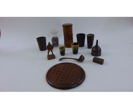 A treen spice tower in five sections, 19th century treen funnel in elm, a timber ladle together with a solitaire board, three