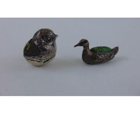 An Edwardian silver novelty chick pin cushion, S Mordan & Co, Chester 1909, modelled as a chick emerging from an egg, height 