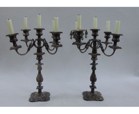 A pair of substantial four branch, five light silver plated candelabra with foliate detail, 46 cm tall