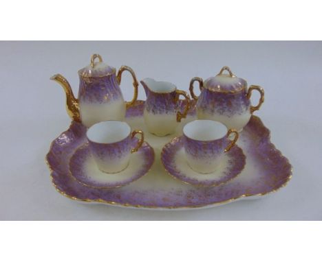 Limoges porcelain tea set comprising a shaped tray, two tea cups and saucers, teapot, sugar basin and milk jug with lilac bor