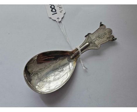 A large silver caddy spoon