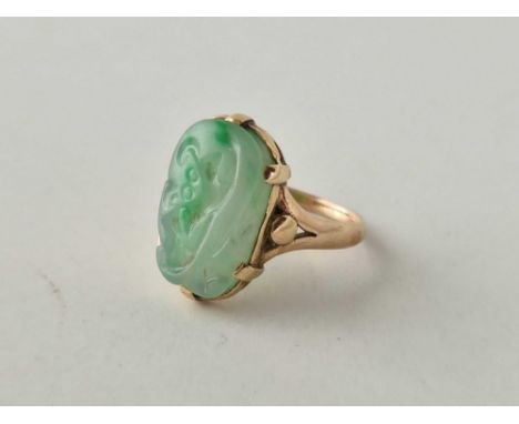 Gold mounted carved Jade ring with a GCS certificate stating the Jade is of natural colour, 6g, size R