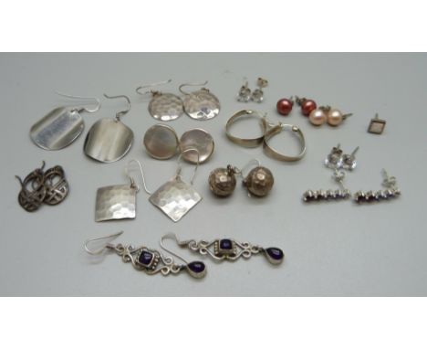 A collection of silver earrings 