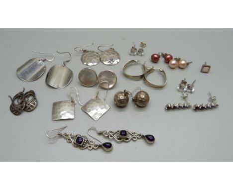 A collection of silver earrings 