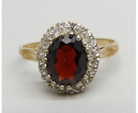 A 9ct gold, garnet and zircon cluster ring, 2.9g, R 