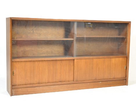 A large vintage retro mid 20th century teak wood bookcase cabinet by Herbert Gibbs. The bookcase of a rectangular form having