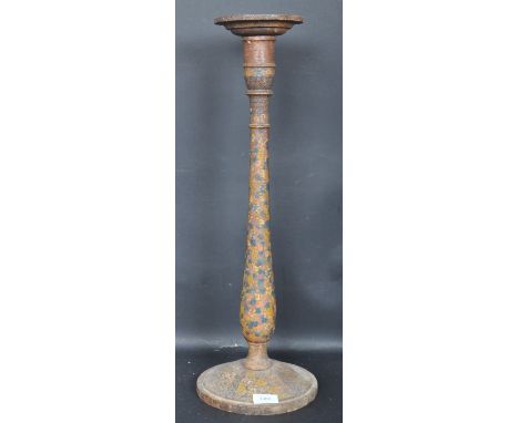 An early 20th century Continental / European folk art candlestick having polychrome floral decoration on a turned column rais