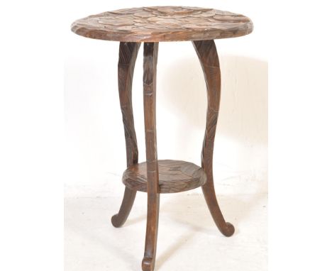A 20th century Japanese carved stained wood occasional table / lamp table. Circa early 20th century, retailed at Liberty of L