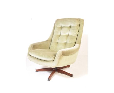 A vintage retro circa 1970’s Danish inspired swivel easy chairs / egg chair. The chair having green velvet upholstery with bu