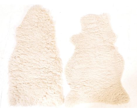 Two vintage retro 20th century sheepskin rugs. The rug of a small proportions finished in natural white colourway. Measures 9