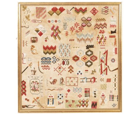 A large framed vintage mid century circa.1970s embroidery needlework textiles sampler featuring various stitched patterns and