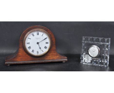 A 20th century circa 1940s oak cased napoleons mantel clock having a white enamel clock face with Arabic numerals to the chap
