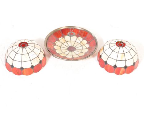A group of three vintage 20th century Tiffany style glass lamp shades to include a pair of half sphere&nbsp; shaped lamp shad