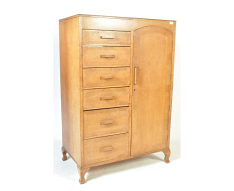 An early 20th century circa 1930’s Art Deco oak gentleman's bachelor compactum. The wardrobe having a single full length door