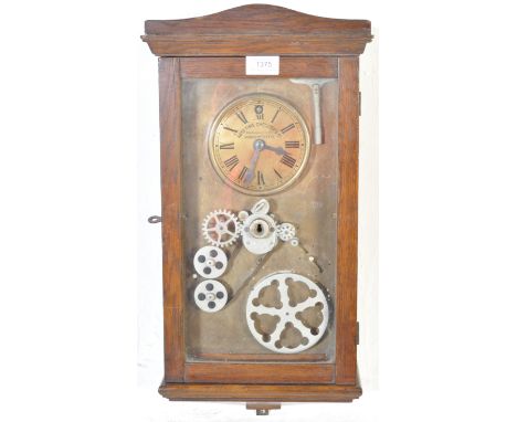 Auto Time Checkers Co of Manchester - An early 20th century wall mounted clock having a glazed front with exposed mechanism. 