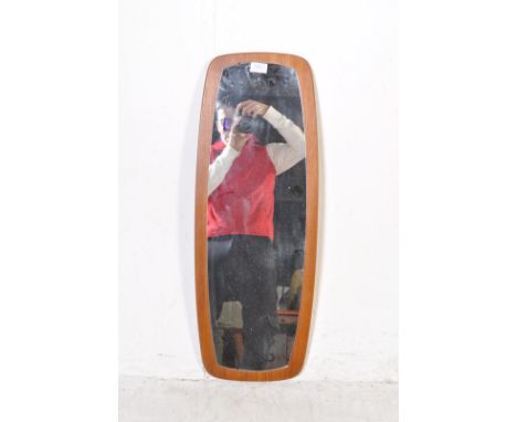 A retro vintage mid 20th century circa 1960s teak wall mirror having a teak show wood frame with oval mirror glass to the cen