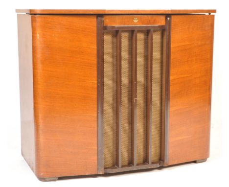 A retro vintage mid 20th century circa 1950s walnut Regentone radiogram having a flip top lid with BSR Monarch record player 