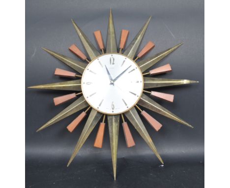 A retro vintage 20th century circa 1960s Metamec wall clock having&nbsp; starburst decoration with teak detailing and Arabic 
