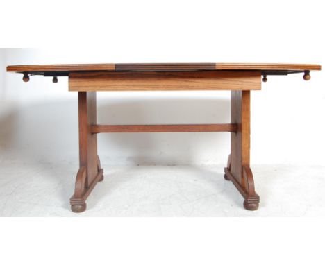 A 1930’s Art Deco oak veneer refectory extending dining table. The table having a two piece top with metal extending mechanis