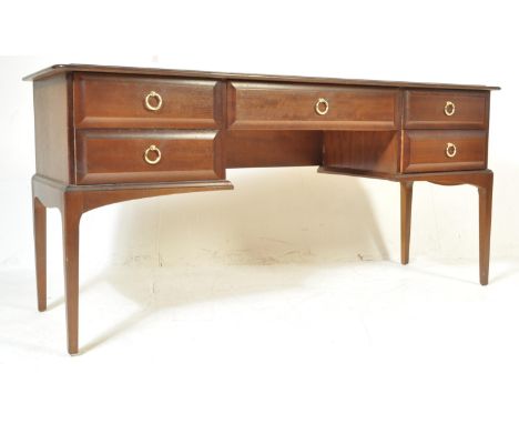 A vintage 1980’s Stag Minstrel African cherry wood dressing table having a single long drawer to the centre over the knee hol