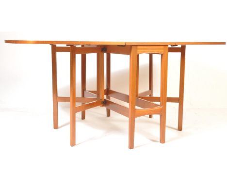 A retro vintage mid 20th century circa 1960s teak double gate leg drop leaf dining table having angles edges with crossbanded