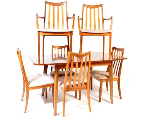 A retro vintage 20th Century teak dining table and six matching chairs. The dining table having an extendible top with centra